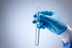 Laboratory researcher holding a test tube for 5-Amino-1MQ research